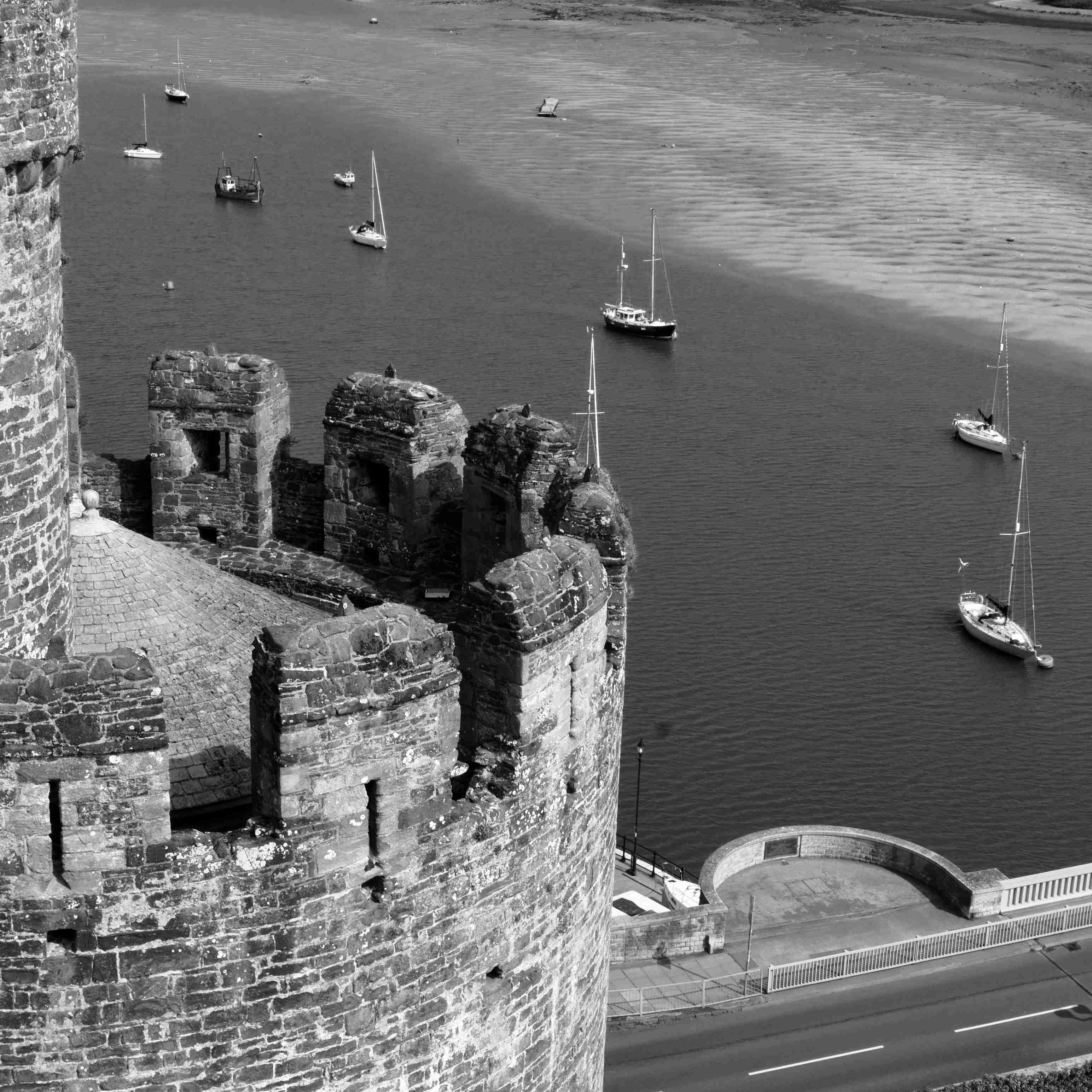 A view from a castle of some boats in an estuary
