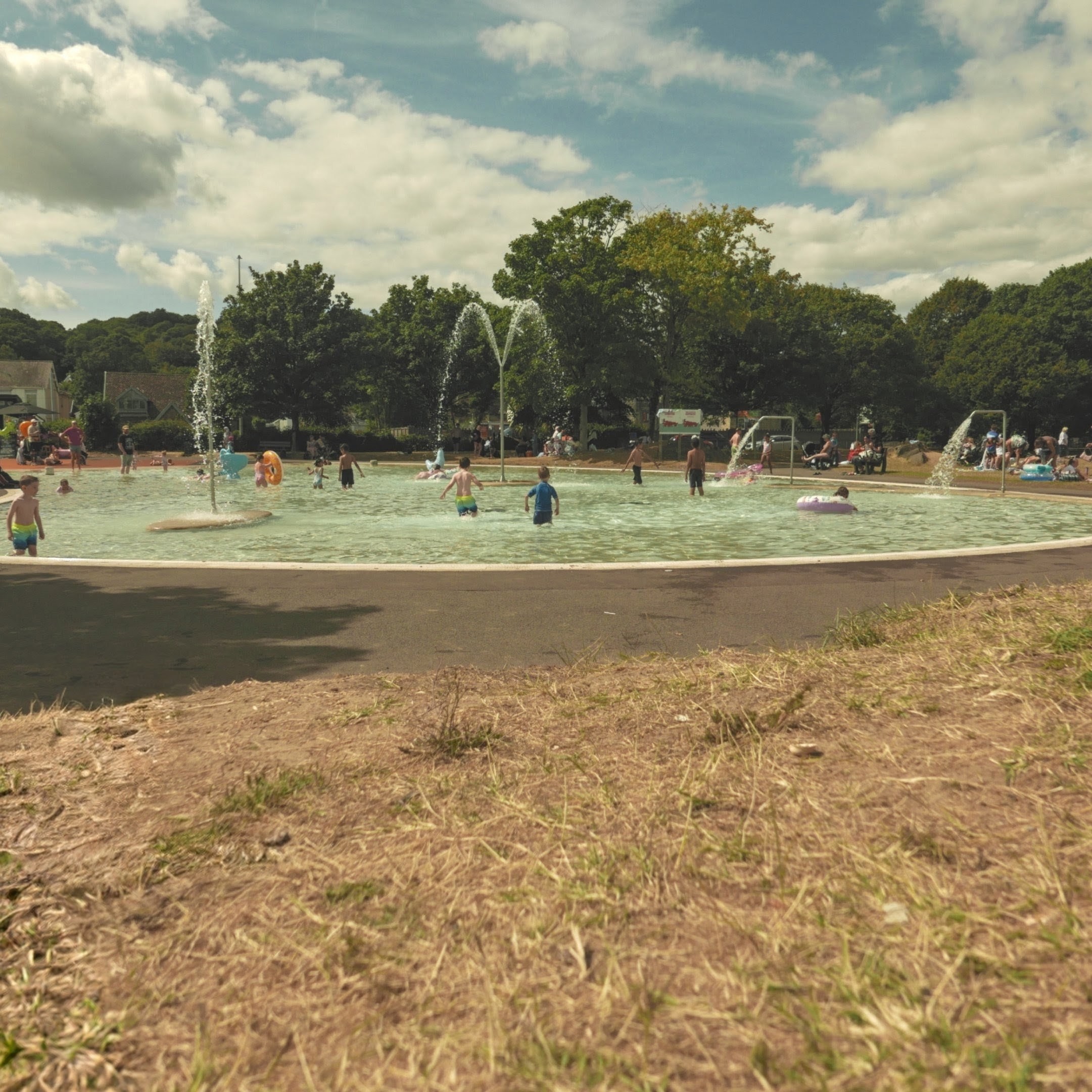 An outdoor kids pool with sprinklers and such.